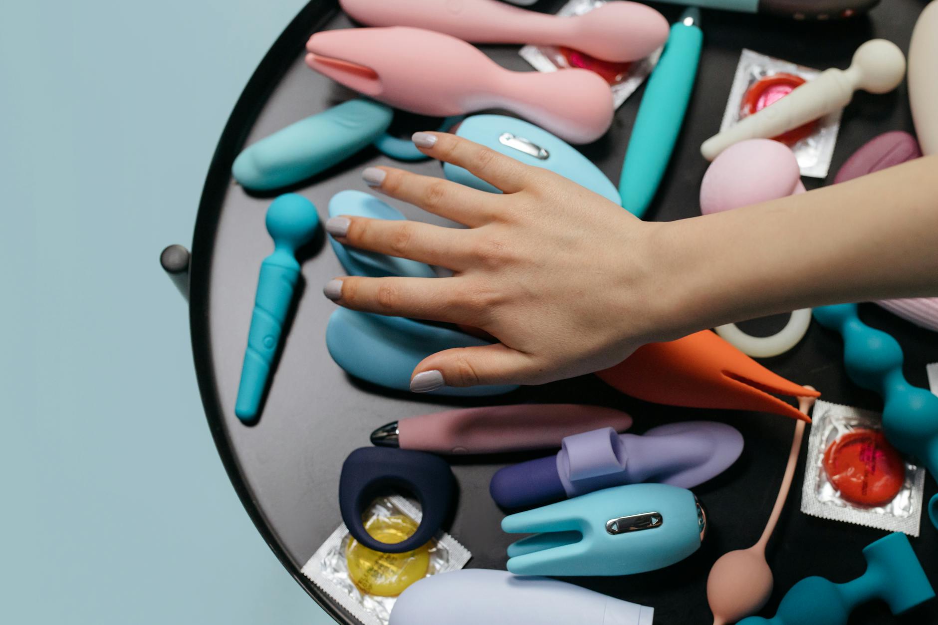 Array of vibrant adult toys including vibrators and rings in a close-up view